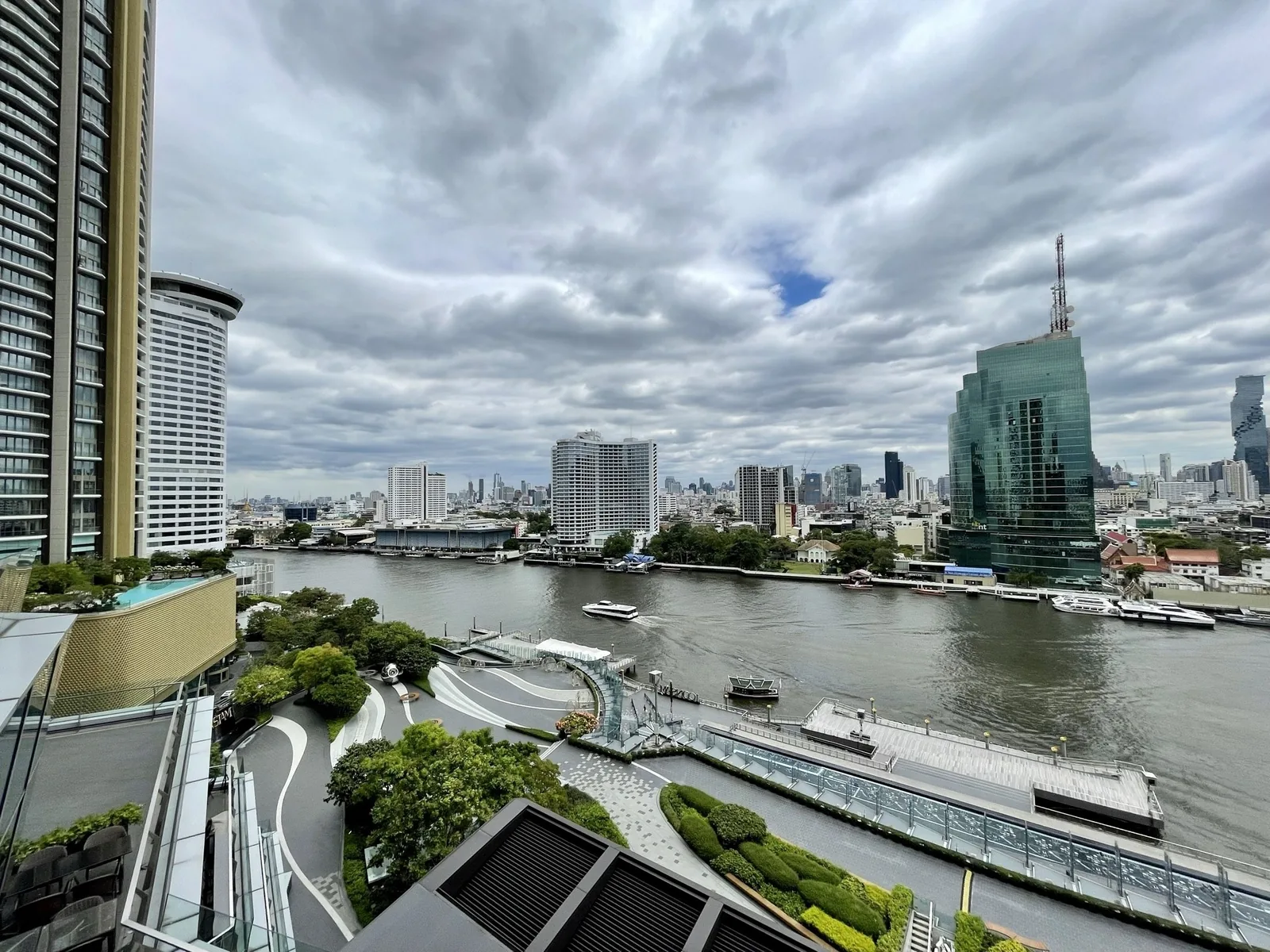 Wide view of the Chao Phraya River and Bangkok skyline seen from a high-rise terrace at Iconsiam.